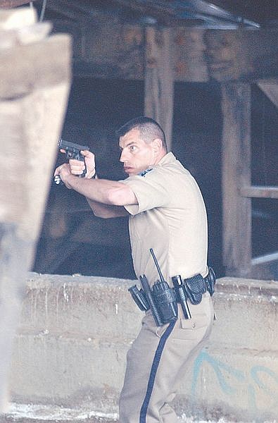 Storey County Deputy Bud Chattin searches an abandonded building in Gold Hill after Troy Enloe escaped from the Storey County Jail in Virginia City. Photo by Brian Corley