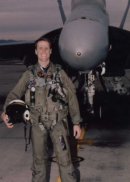 United States Navy jet pilot Lt. Cmdr. Arthur Jason Bayer poses in front of