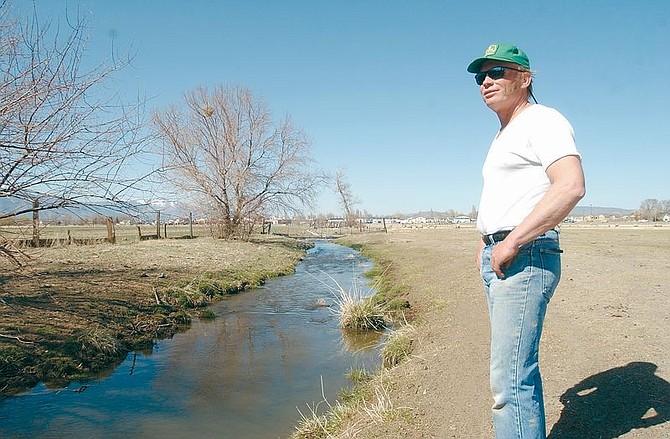David Hussman stands next to a ditch that runs through his 360 acre property in Garnerville. Hussman is chairman of the Douglas County Water Conveyance Committee, which oversees access to Carson Valley&#039;s water for irrigation and drainage. Photo by Brian Corley