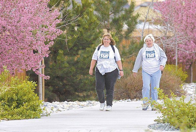 Photo by Cathleen AllisonCindylou Kibbe (left) and Susan Staron-Draper walk home from Western Nevada Community College on Monday morning. The two are training to walk the 60-mile Avon Breast Cancer 3-Day to raise money for cancer treatment and for finding a cure.
