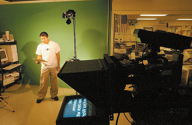 CHS student Jesus Ramirez reads the  announcements in Spanish during a school wide broadcast.  The bilingual portion of the School broadcastl orininates from Video instructor Brian Reedy&#039;s studio within the school.