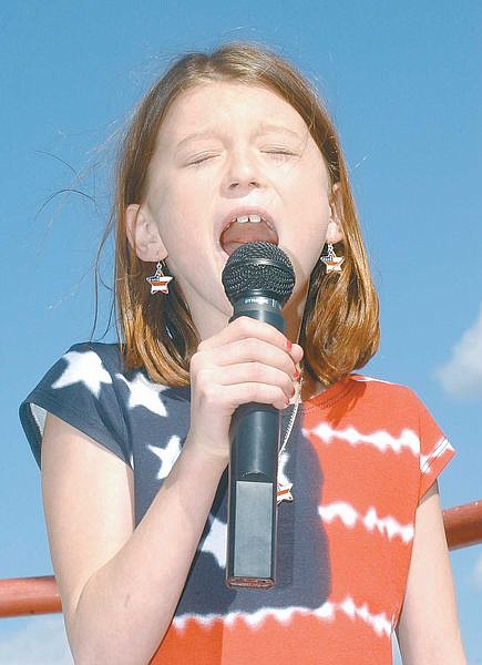 Cethe Choux, 9, sings the Star Spangled Banner at Champion Speedway&#039;s opening day Sunday.