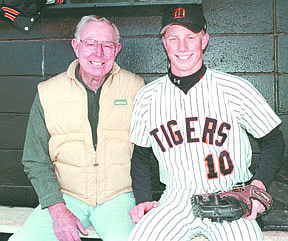 Karl Olson, left, and grandson Erik Olson share a moment together in the Douglas High School dugout before a game betweeen the Tigers and McQueen Landers. Photo by Dave Price