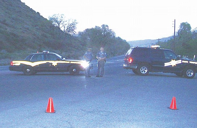 Nevada Highway Patrol troopers run a roadblock on Highway 395 in Pleasant Valley on Wednesday night. A Reno man was shot and killed by officers during a confrontation on the highway. Photo by Jim Scripps