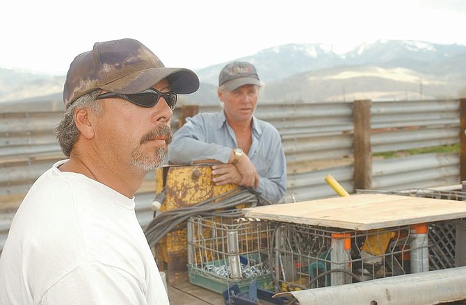 John Hicks, left, and Anthony Tomlinson were two the eight inmates who constructed the 11 acre holding area for captured mustangs out of mainly recycled materials. Photo by Brian Corley