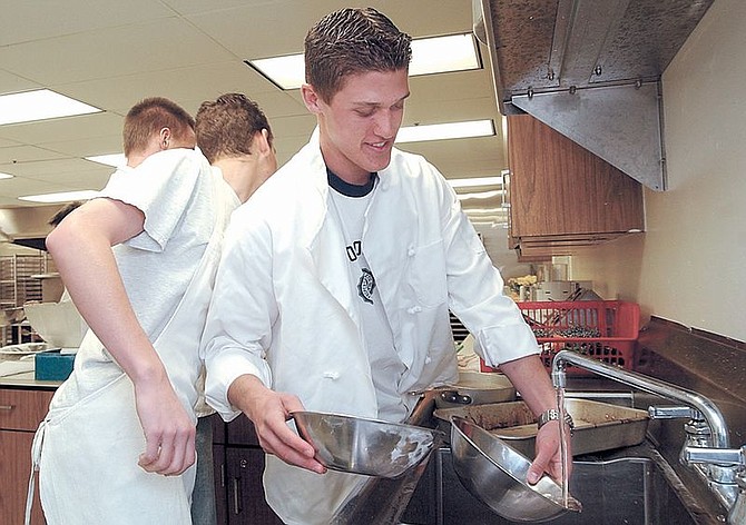 Right to left, CHS culinary student Jared Wulff washes dishes Tuesday afternoon with Nick Ryan and Corey Stockhoff after the water was turned back on at the High School and aproved for consumption.  photo by