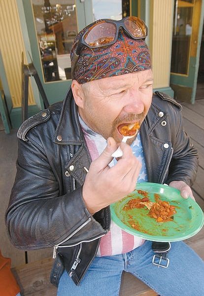 Ronnie Huf tries out chili along C Street in Virginia City during the Virginia City Chili Cookoff Sunday. Photo by Brian Corley