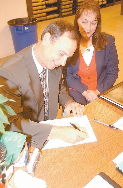 Kenneth Furlong fills out paperwork for running for the office of Carson City Sherriff as his wife, Phyllis Furlong, looks on. Photo by Brian Corley