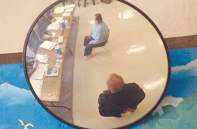 Nevada State Prison inmate Jack Mazzan , center is reflected in a mirror while attending a  Nevada State Parole board hearing Thursday morning within the prison. Maazan was convicted of killing Richard Minor Jr. son of a Reno Judge and spent more than 20 years on death row
