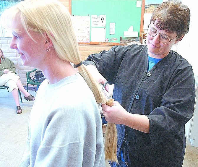 Brian Corley photoAbby McCannon, right, makes the first cut -- ever -- in Tracy Balik&#039;s long blond hair on Friday.