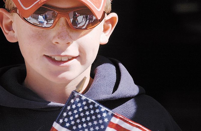 Evan Zemp, 10, of Bordewich Bray holds his flag that he received during a flag presentation ceremony at the school Friday morning. The assembly included local speakers including members of the Carson Host Lions club and Judge Robey Willis.  photo by Rick gunn