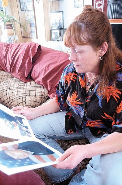 Shayne Parker looks at photos of her son, John Paul Ortstadt, who is serving in Kandhar, Afganistan as a maintance crew chief for cargo planes. Photo by Brian Corley