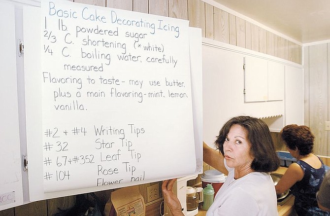 English-as-a-second-language student Maria Franchini opens a cabinet with a recipe in English attached to it.