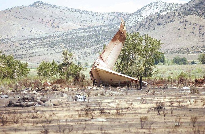 Brian Corley photo.The tail section of a C-130A air tanker which crashed Monday sits near Highway 395 on Tuesday in Walker, Calif. The plane lost its wings and nose-dived while battling the Cannon fire, killing all three on board.