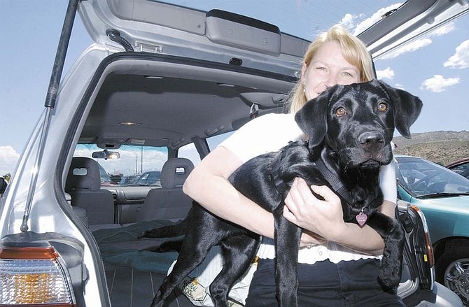 Corrine Petra holds her Lab Callie Tuesday afternoon in the Wal-Mart Parking lot.  With temperatures in the 90&#039;s Corrine brought Callie to the pet store with her instead of leaving her in the car.