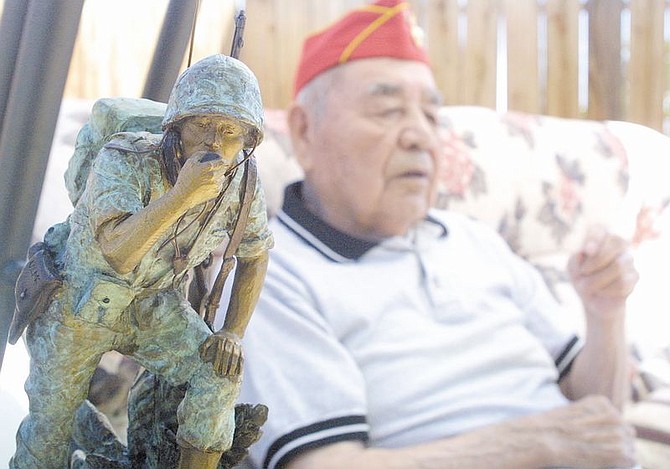 Karl Crawford talks about his days as a code talker during World War II, from his daughter&#039;s Mound House home.  Crawford served in Guadalcanal in 1943.  He is seen with miniature version of the bronze code talker statue sculpted by Oreland Joe for the Southewest Indian Foundation in 2001. &#124; Photo by Cathleen Allison