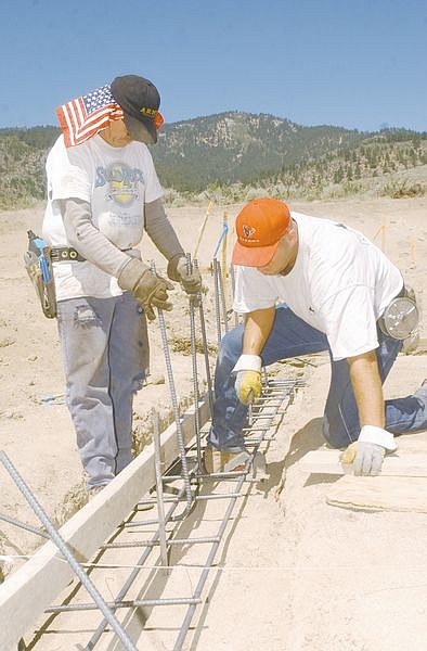 Jason Stead, left, and Bob Schirlls, apprentice with local Ironworkers union 118, volunteer time at the Western Nevada Community College Observatory construction site to get on the job training in laying the foundation for the observatory. photo by Brian Corley