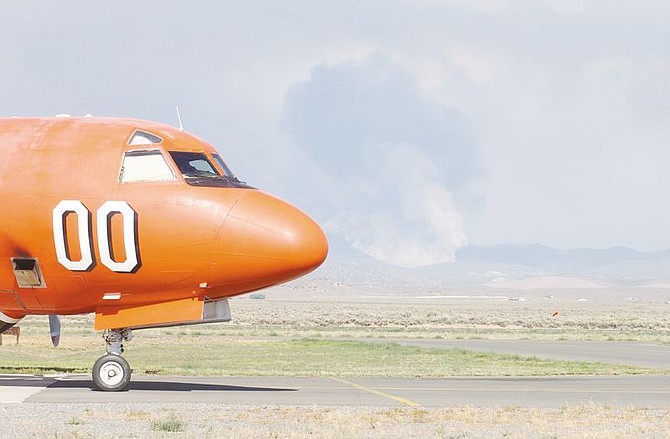 A P-3 Orion Air Tanker waits as it reloads to fight the Buckeye Fire south east of Johnson Lane. The fire, which was started by lightening, was inaccessable by the ground so was fought by a lone tanker as several others helped with other fires in the area. photo by Brian Corley