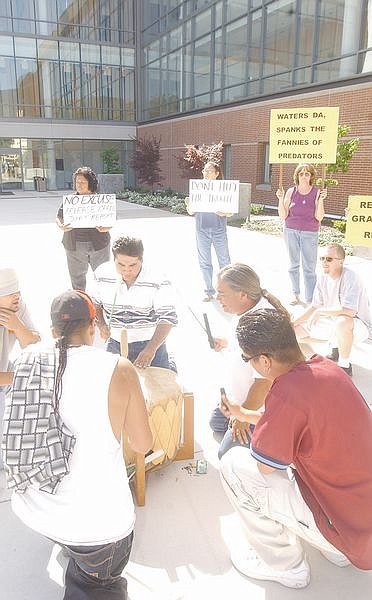Native Americans sing songs to a drum as protesters gathered in front of the Carson City Courthouse when it was announced that the Resendiz Grand Jury report was not released. Photo by Brian Corley
