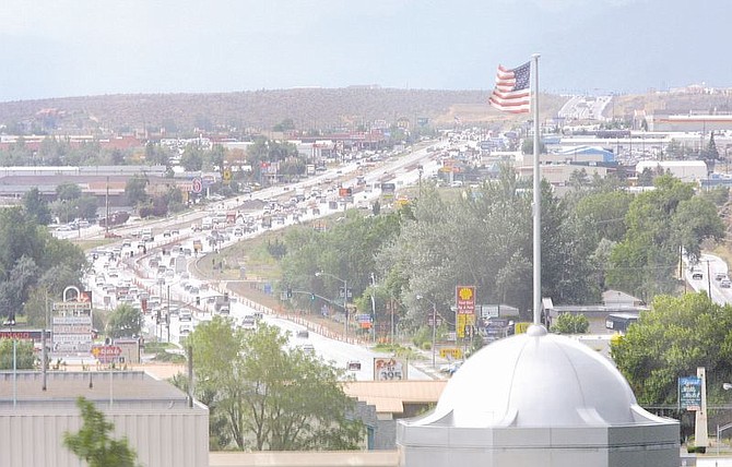 Travelers face summer thunderstorms as they wend their way down South Carson Street, as seen from the top of the Capitol, Thursday. South Carson Street is traveled by by an estimated 45,000 cars daily and is undergoing construction that includes an expansion from four to six lanes and new sidewalks. The $2.1 million overlay project should be done in August.