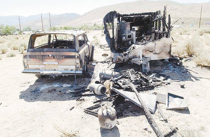 Photo by Rick GunnA burnt-out trailer and Cherokee Chief stand near the intersection of Clear Creek Avenue and Horario Lane in south Carson on Tuesday. Arson is suspected.