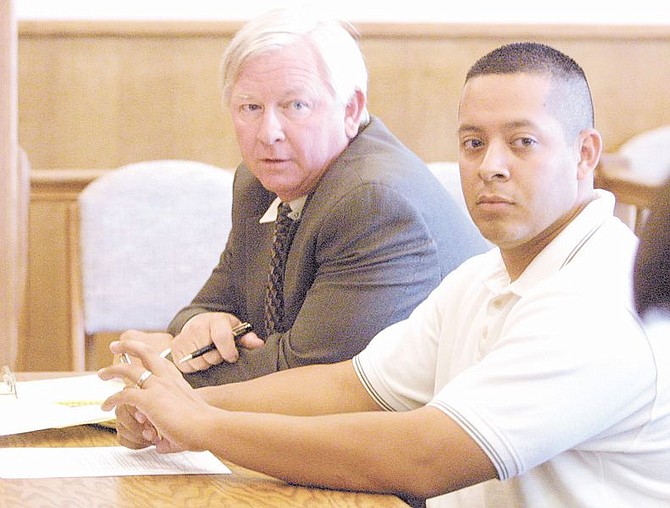 Desi Navarro, right, the former Dayton High School girls&#039; basketball coach listens to the proceedings on Wednesday afternoon in Dayton Justice Court, with his attorney Ken Ward, left. Navarro faces felony charges for allegedly having sex with a 16-year-old student.