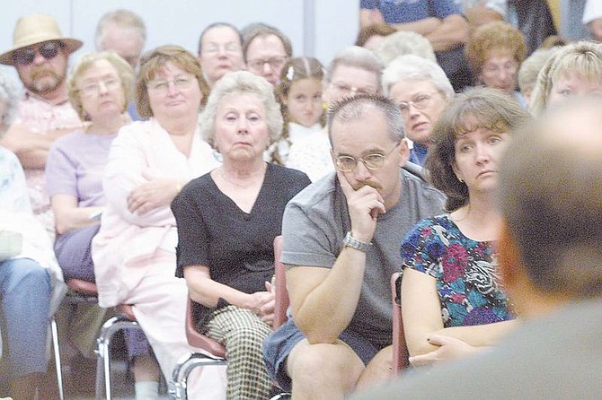 Audience members listen intently during Thursday&#039;s League of Women Voter&#039;s forum for Carson City sheriff candidates. About 100 people packed the Sierra Room to question the five candidates before the Sept. 3 Primary Election. Candidate Kenny Furlong is in the foreground to the far right answers a question about drug problems in Carson City.