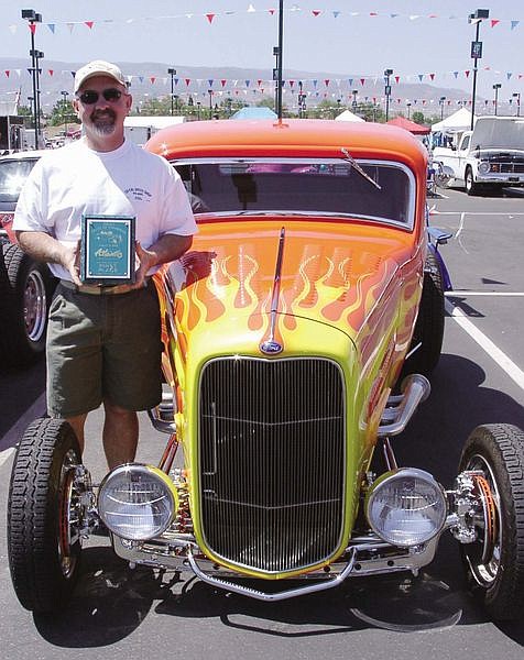 Tom Christian stands next to his 1932 Ford Hiboy Coupe, which won &#039;Best of Local Cruiser&#039; at the Atlantis Cruise competition on Tuesday. Christian bought the Hiboy two years ago and fully restored it.