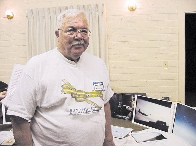 Harry Vandelinder stands nex to photographs he took while piloting a B-17 during WWII. Vandelinder was one of several veterans who spoke at the WWII Evening of Memories- Operation Lasting Impression in Coleville Thursday.