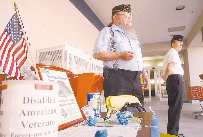 Jim Billig, left, Senior Vice Commander for Disabled American Veterans in Carson City, and Marvin Smith a Carson High School Junior Reserve Officer Training Candidate collect money in front of Lowes for disabled veterans. Photo by Brian Corley