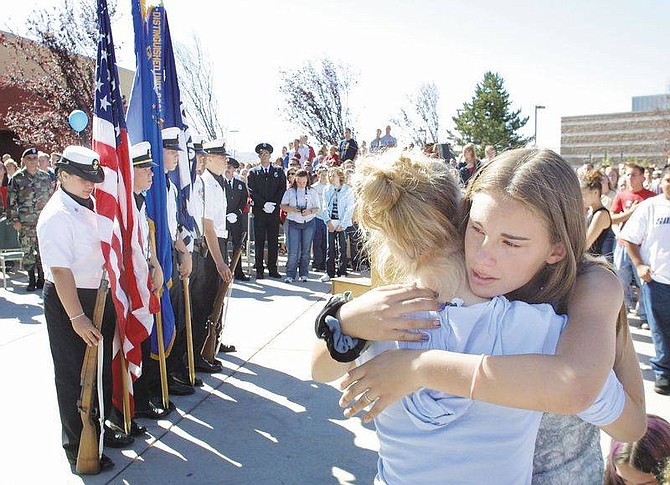 Cathleen Allison photoTina Ellington, right, hugs Kelly Taylor, both 14, during the Carson HIgh School memorial service on Wednesday morning.