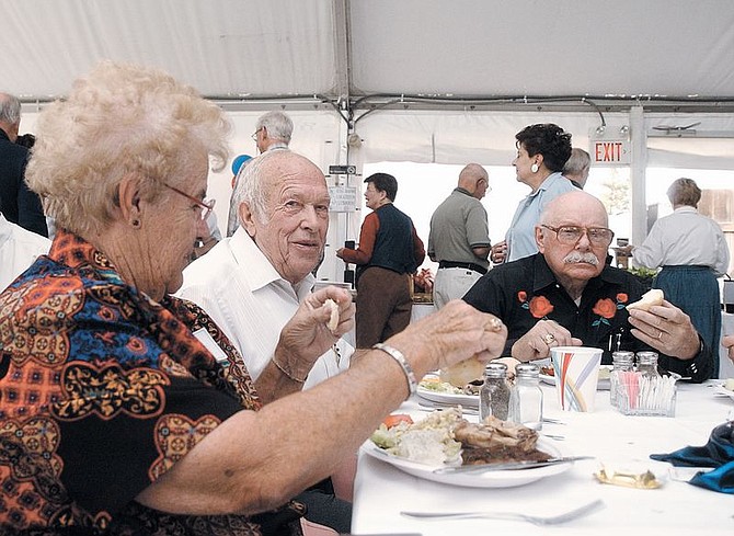 Betty and Lawrence Jacobsen, left, sit with Ed Harris, a former Lyon County Republican Central Committee member, during a barbeque in honor of Jacobsen. harris said he could count on jacobsen for support when he needed it. Photo by Brian Corley