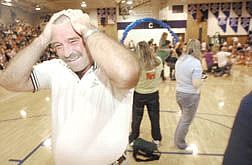 CHS welding instructor Charles Shirley reacts after getting his head shaved during at an assembly in the CHS gym Thursday afternoon. Five teachers were brought to shears during the homecoming assembly.