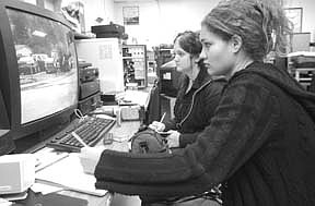 Ashley Masek, 16, (left) and Joedee Moniz, 17, review video shot at Bordewich-Bray Elementary School. The students in the Carson High School video production class are documenting problems at the school for the 2002 bond issue. Photo by Rick Gunn.