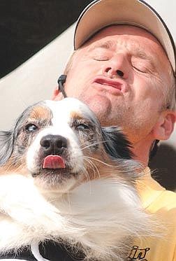 photo by rick GunnDog trainer Dave Whitworth reacts just after Bandit sneaks a kiss. Bandit was saved from the pound and now performs in the Beggin&#039; Strips dog show. The traveling show took place at the RSVP carnival Friday afternoon at Mills Park.