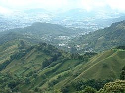 Similar to Carson City, San Jose, Costa Rica, is surrounded by mountains. But because of the high amount of rain the area gets, the mountains are a lush green instead of blue.