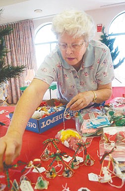 Iona Biggs sets out Christmas Tree ornaments Friday afternoon in prepartion for the Santa&#039;s Village Craft sale at the Carson City Senior&#039;s Center. Crafts and baked items will be sold Saturday and Sunday as well providing entertianment and food. Photo by Brian Corley