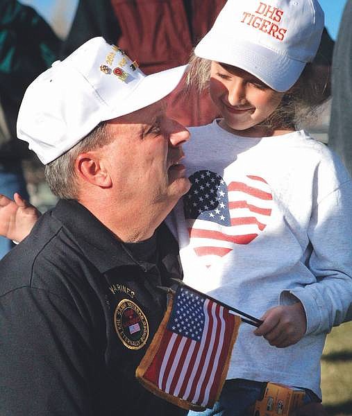 Photo by Cathleen AllisonSteven Orr and his daughter Katie, 7, of Gardnerville, share a quiet moment following the dedication ceremony for the state Vietnam Veteran&#039;s Memorial at Mills Park on Monday afternoon.
