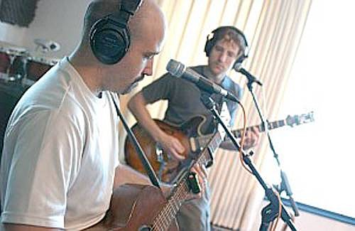 Multi-instrumentalist and bandleader Tony Furtado, left, continues to reinvent and redefine his musical persona with a band member in the studio recently. He plays the Brewery Friday at 7:30 p.m.