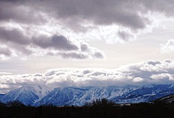 Clouds come over the mountians south of Carson City Friday afternoon. Photo by Brian Corley