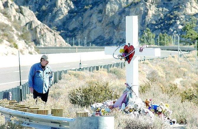 Rick Gunn/Nevada Appeal  Gary James, looks over the memorial dedicated to Krystal Steadman Friday afternoon. The Nevada Department of Transportation is scheduled to remove the memorial next week. James has helped maintain the memorial. photo by Rick Gunn
