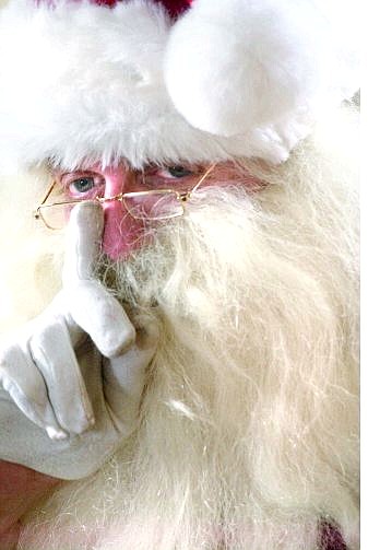 Rick Gunn/Nevada Appeal Santa touches his nose for good luck Saturday as he gets ready to greet the kids on the Santa Train at the Northern Nevada Railroad Museum.