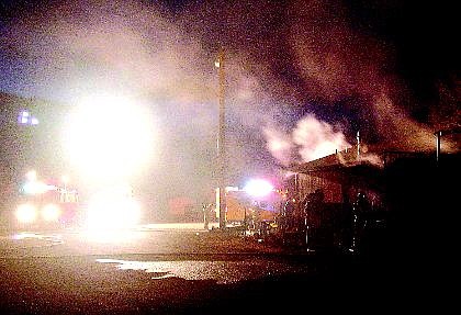 Smoke billows from the Capitol City Trap Club on Arrowhead Drive Saturday night after turkey fryers caught fire, igniting the building. An elderly man suffered a cardiac arrest during the fire. Paramedics revived him with electric defibrillators.