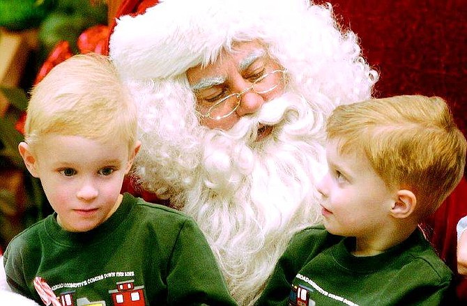 Rick Gunn/Nevada Appeal Brady, left, and Brandon Steel, both 3, sit on Santa&#039;s lap at the Carson Mall on Tuesday. Santa will return from 11 a.m. until 3 p.m. today.