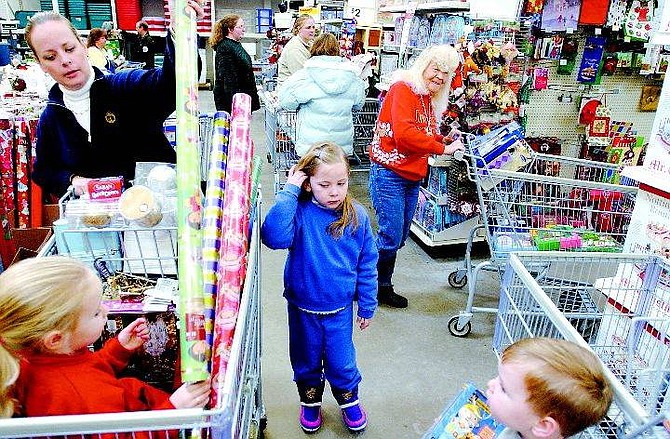 BRAD HORN/Nevada Appeal Hansina Mickschl, from left, shops for bargains with her children Morgan, 5, Madison, 6, and Zachary, 2, at the Wal-Mart store Friday morning.