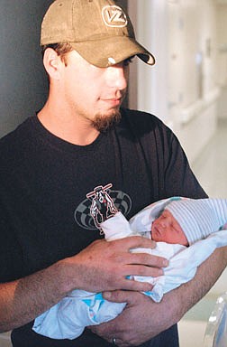 Cory Breckenridge holds his newborn baby son Ian Tuesday afternoon at Carson-Tahoe Hospital. It was Carson City&#039;s first baby of the year.  phot by Rick Gunn