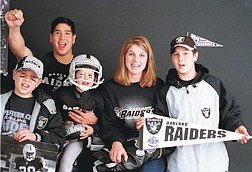 Photo by Belinda GrantCheering for the Oakland Raiders is mandatory for the Cruz family, from left, Jordan, Ken, Leo, Joanne and David.