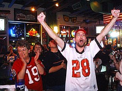 Canstance Autry, left, claps to a Tampa Bay Buccaneer touchdown as her son, Jonathan Balleweg, raises his arms at Bully&#039;s Sports Bar Sunday in what was to become a high scoring Super Bowl XXXVII. Photo by Brian Corley