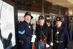 Harry Ehrman, left, Ken Auld and Richard LeVee stand in front of the Carson City Movie Theaters in an effort to recruit for the 2nd U.S. Infantry Company C Civil War reenactors. The movie God and Generals, based on the best selling novel and prequel to the movie Gettysburg that climaxes at the Battle of Chancellorsville in 1863, has sparked a new interest in Civil War reenacting which some of the enthusiasts hope to use to draw in new members. Photo by Brian Corley