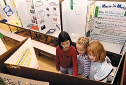 Fritsch third-graders Taylor Nakamoto, Caitlin Jones, and Taylor McAninch, all  9, looked through the display of science fair projects. Schools throughout Carson City have been holding science fairs over the past two weeks. Photo by Rick Gunn.